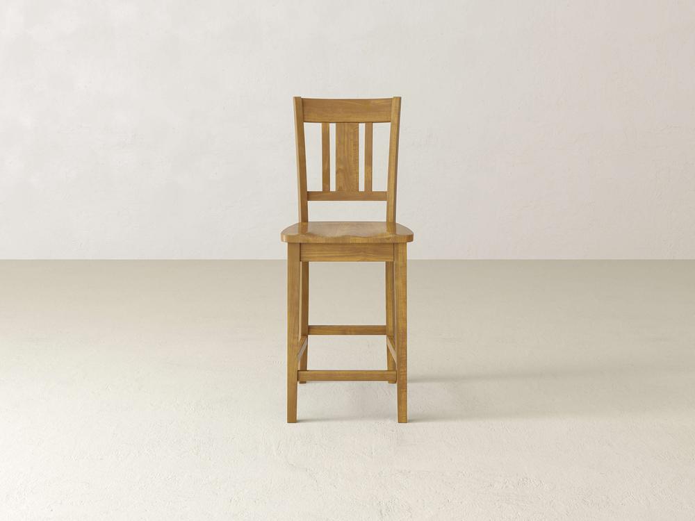 The William Stool by James & James, featuring a wooden design with a slatted backrest, is set against a plain light background. Its timeless sophistication and classic lines with natural wood finish make it ideal for any home decor.