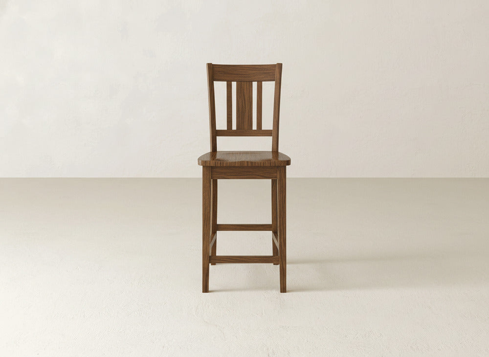 The James & James William Stool features a handcrafted slatted backrest and square seat, shown on a plain, light floor against a beige wall—ideal for enhancing your home decor.