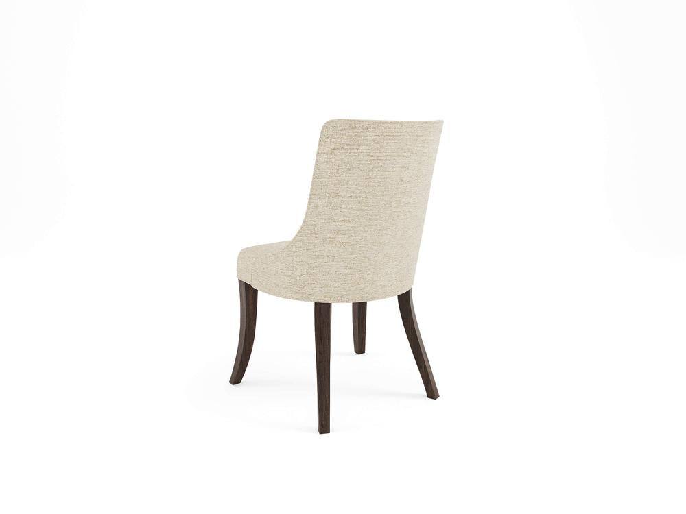 A beige upholstered chair with a curved back and dark wooden legs, shown from a rear angle on a white background.