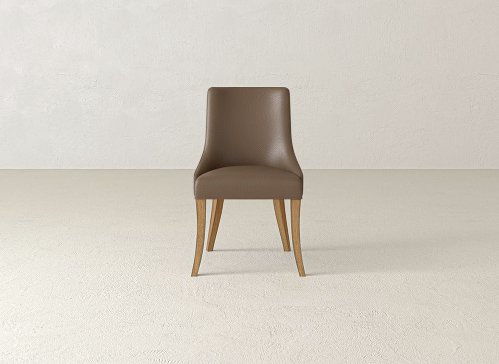 The James+James Willow Dining Chair features a curved backrest and four light wooden legs, positioned on a light-colored floor against a plain, lightly textured wall.