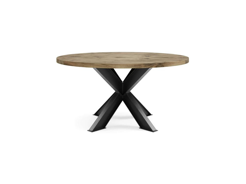 The Shiloh Round Dining Table - Harvest Wheat by James+James features a sturdy X-shaped black metal base and a natural wooden finish. Its clean, modern design makes it suitable for dining or as a statement piece in any room.