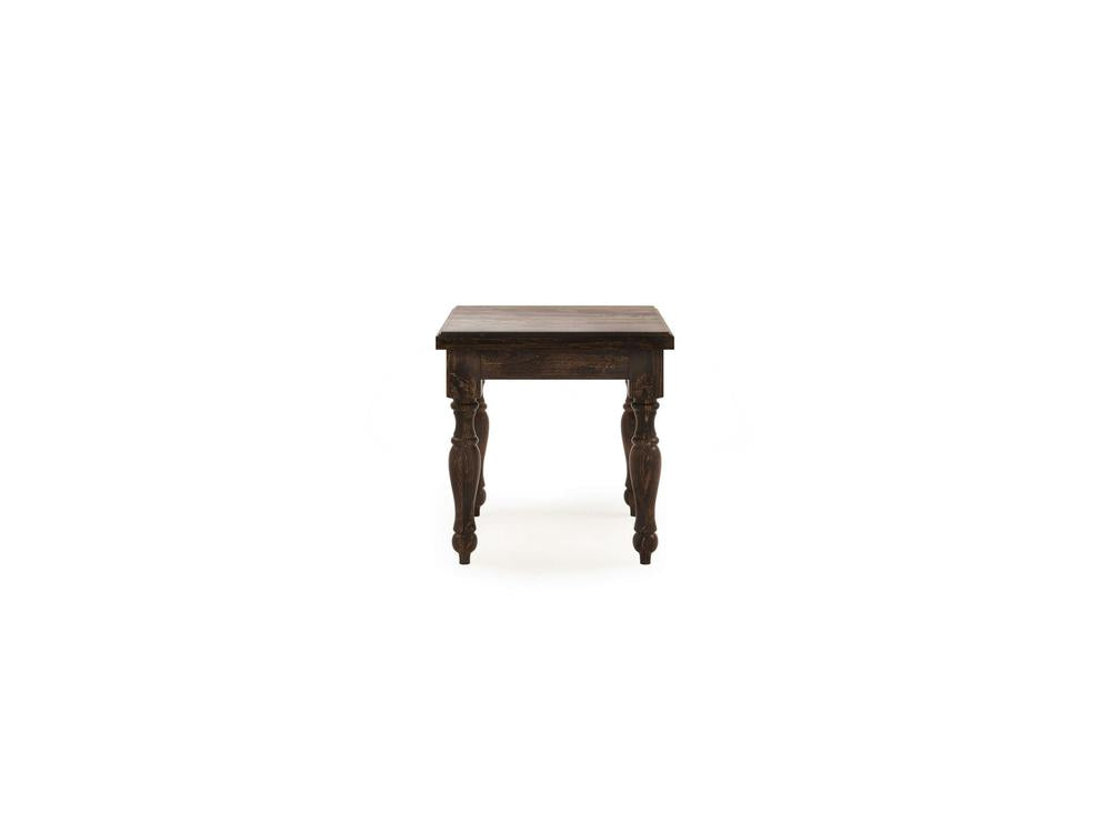 The Abigail End Table in Tobacco by James+James is a compact piece with a dark wooden, square top and four intricately carved legs. This table exudes a rustic charm and is set against a white background.