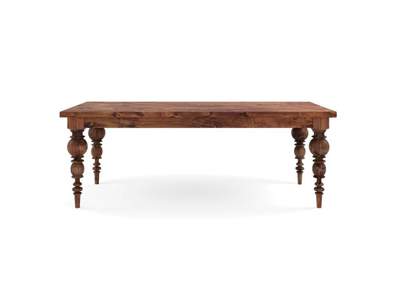 The Bailey Dining Table - Tuscany by James+James features a rectangular top and four intricately carved legs, showcasing natural grain with a medium-brown finish. Its heirloom design blends classic charm and modern elegance, making it a timeless dining space centerpiece.