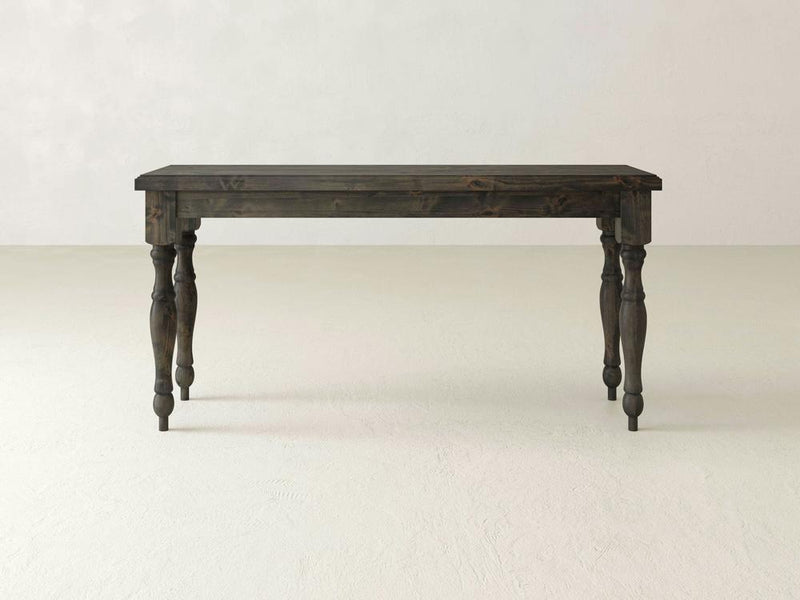 A dark wooden James+James Abigail Sofa Table with a rectangular top and four intricately carved legs is set against a plain, light-colored background. Its timeless charm is evident in the classic and robust design.