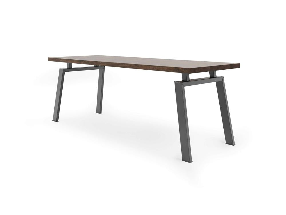 The Fulton Desk - Tobacco by James+James is a minimalist, modern desk featuring a rectangular wooden top with a dark wood finish and angled metal legs in a gray color. The desk boasts an open design with a simple, sturdy frame, perfect for any contemporary space.