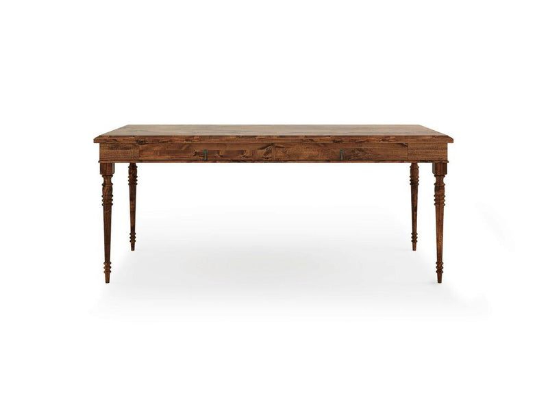 The Audrey Desk - Tuscany by James+James is a rectangular wooden piece with a rustic, natural finish. It features four intricately carved legs with spindle designs, giving it a classic and elegant look. The surface beautifully showcases the wood's natural grain, adding to its vintage charm.