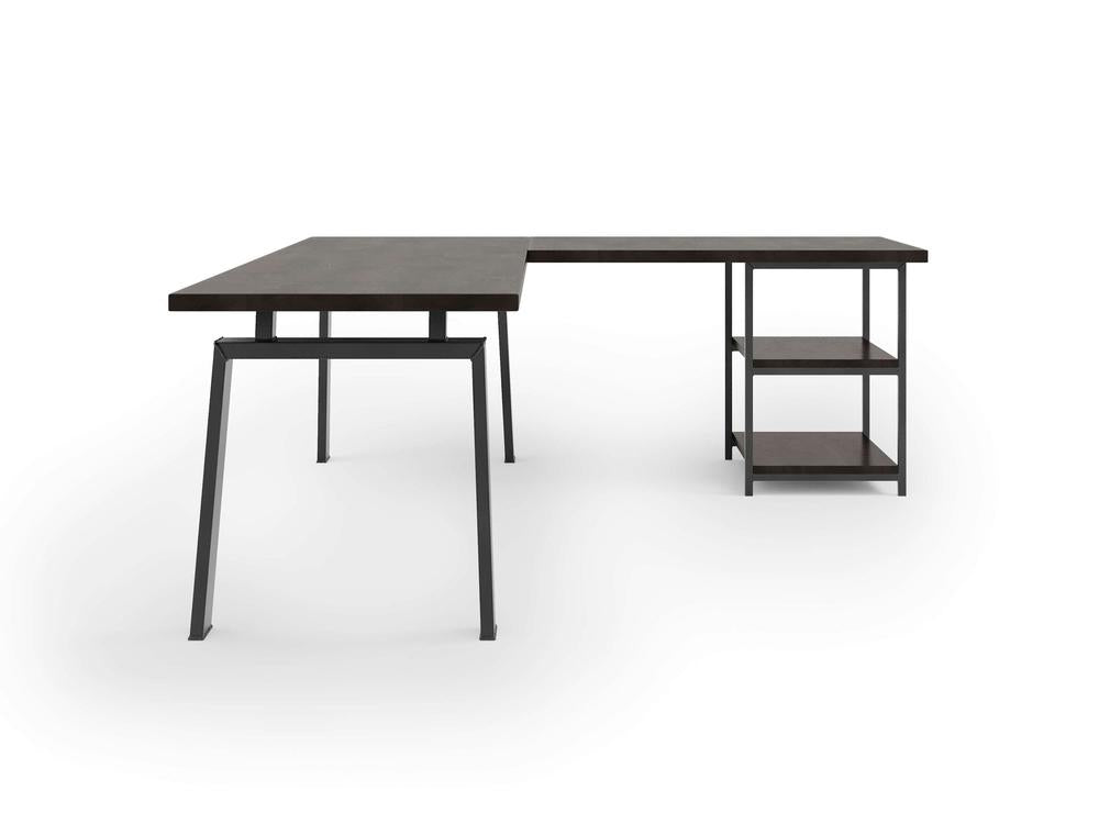 The Fulton Corner Desk by James & James features a modern L-shaped design with a charred ember top and black metal legs. One side serves as a standard desk, while the other extends perpendicularly with two open shelves for extra storage against a plain white background.