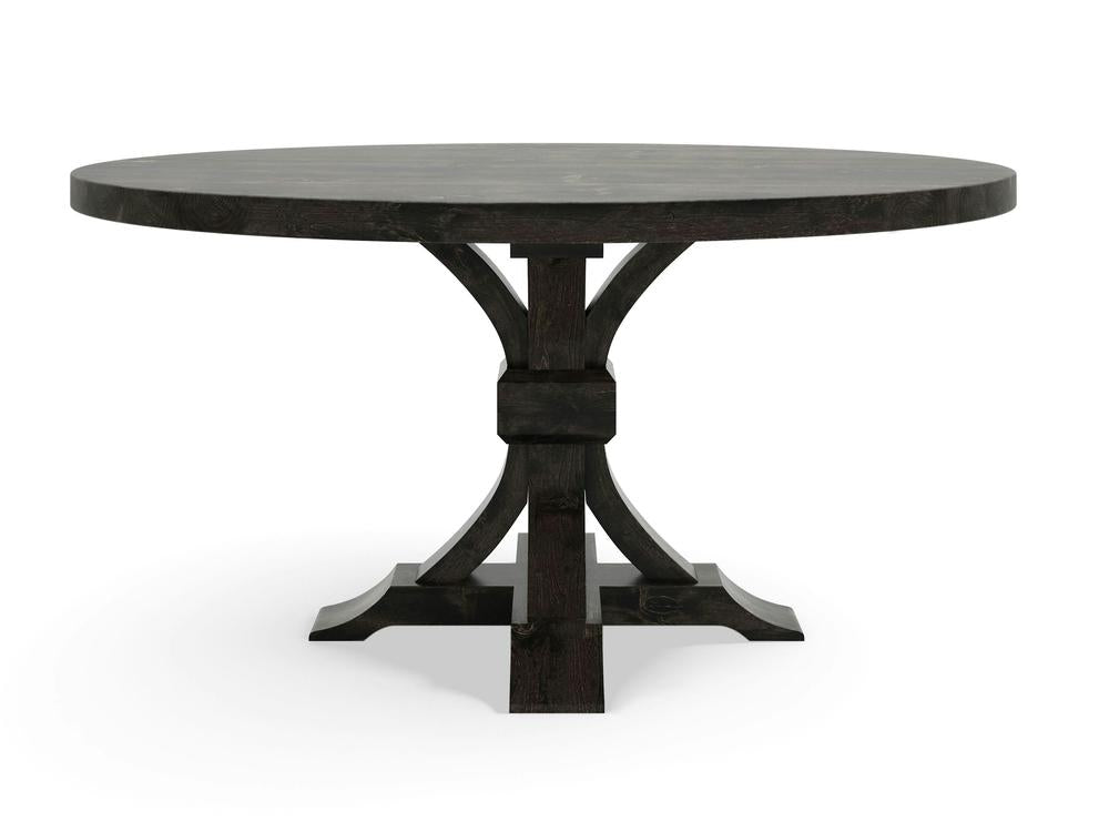 The Violet Round Dining Table - Charred Ember by James+James is a round wooden dining table with a dark finish. It features a sturdy, wide pedestal base with four supporting curved legs that converge in the middle, creating a balanced and elegant appearance. The smooth and clean surface makes it suitable for various settings.