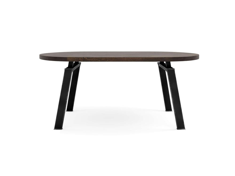 The Fulton Oval Dining Table - Tobacco by James+James showcases a dark brown oval top with refined, rounded edges. It stands on four black, sturdy metal legs that are slightly angled outward, epitomizing a modern and minimalist design against the white background.