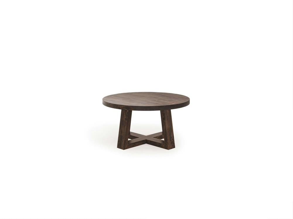 The Rae Coffee Table - Tobacco, from James+James, is a wooden round table with a dark brown finish. It features a modern design with a thick tabletop and a unique X-shaped base for support. The table is set against a plain white background.