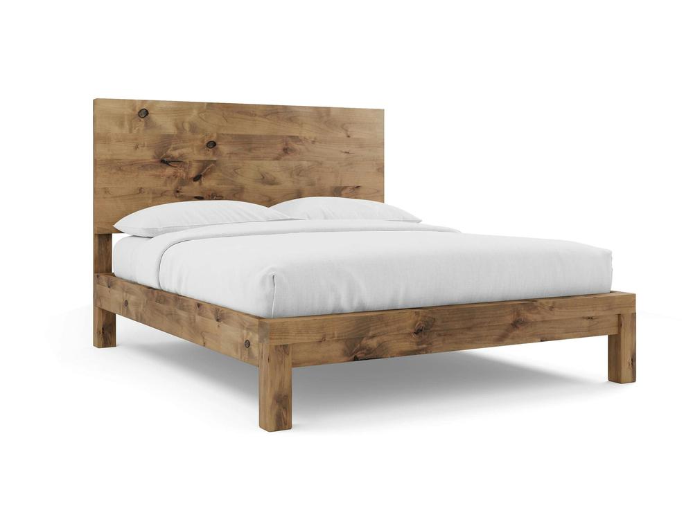 The Sawyer Bed - Harvest Wheat on Alder by James+James features a simple, modern wooden frame with a rectangular headboard showcasing visible wood grain and knots, topped with a white mattress, sheets, and two pillows.