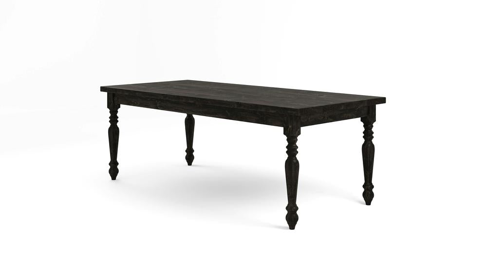 A French Country Dining Table - Charred Ember from James+James, featuring a rectangular top and four turned legs, sits against a plain white background. The black wooden table boasts a rustic design with a distressed finish, evoking a vintage or farmhouse style.