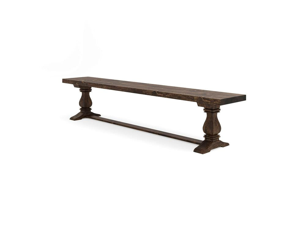 The James+James Heirloom Bench - Tobacco on Alder features a rectangular wooden seat and two carved pedestal legs connected by a horizontal support bar for timeless style.