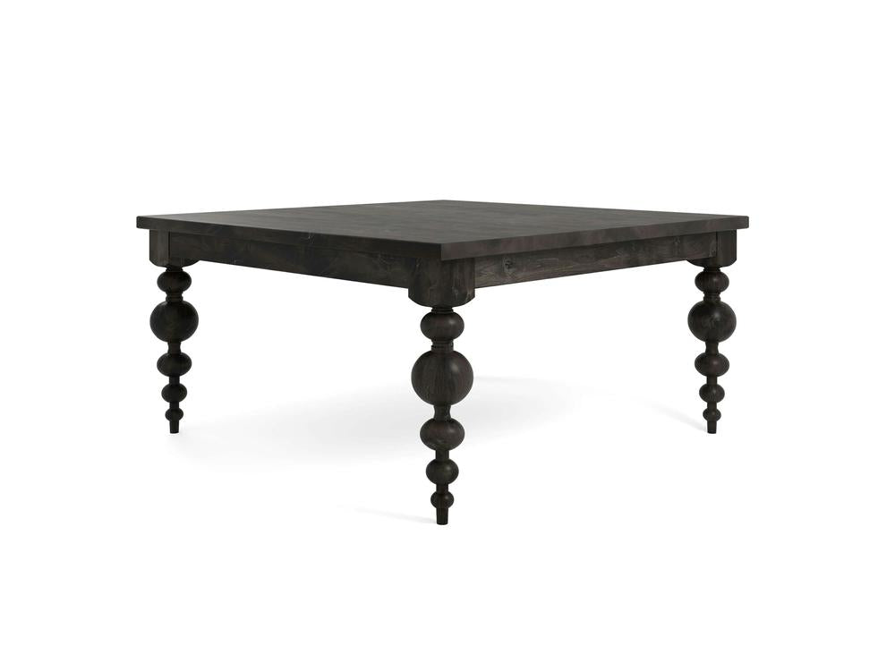 The Olivia Square Dining Table - Charred Ember by James+James features a dark wooden design with four thick, intricately turned legs. Its sleek and polished surface offers a modern yet classic aesthetic, making it perfect for a dining area or as an accent piece in a living space.
