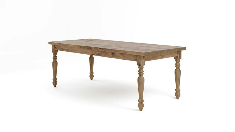 The French Country Dining Table - Harvest Wheat by James+James features a rectangular wooden top and four intricately carved legs. The table's natural wood finish beautifully showcases its grain and texture, combining traditional design with functional elegance. The background is plain white.