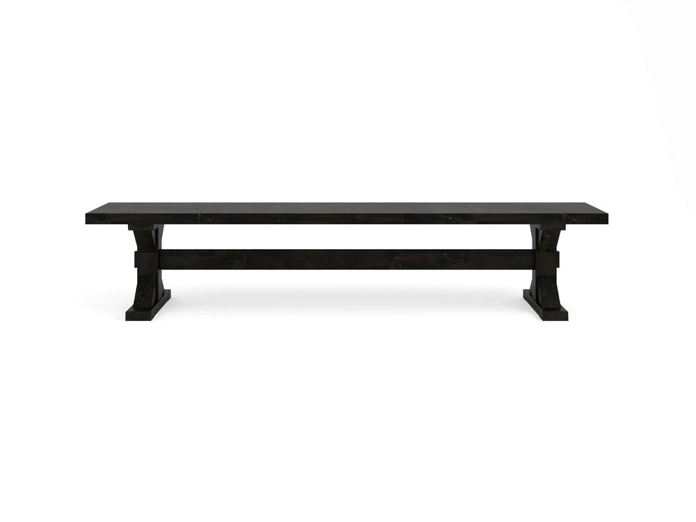 The Trestle Bench - Charred Ember on Alder by James+James features a long, dark rectangular top and sturdy trestle legs, shown against a plain white background.