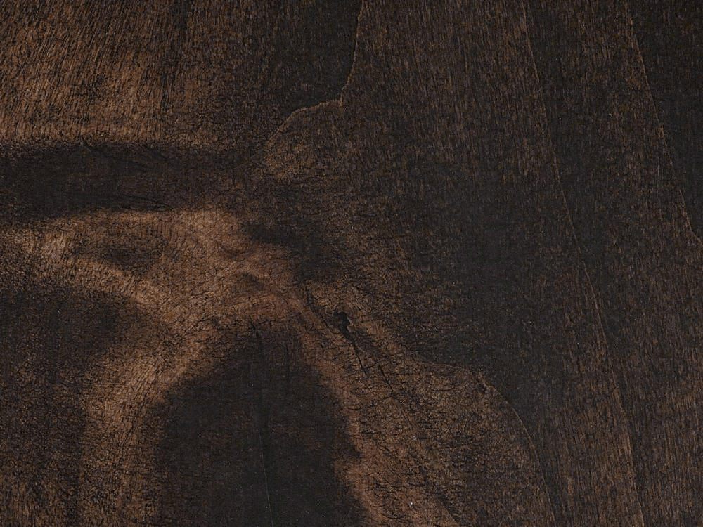 A close-up of the Olivia Bench - Tobacco on Alder by James+James, showcasing its dark brown alder wood surface with visible grain patterns and natural texture variations.